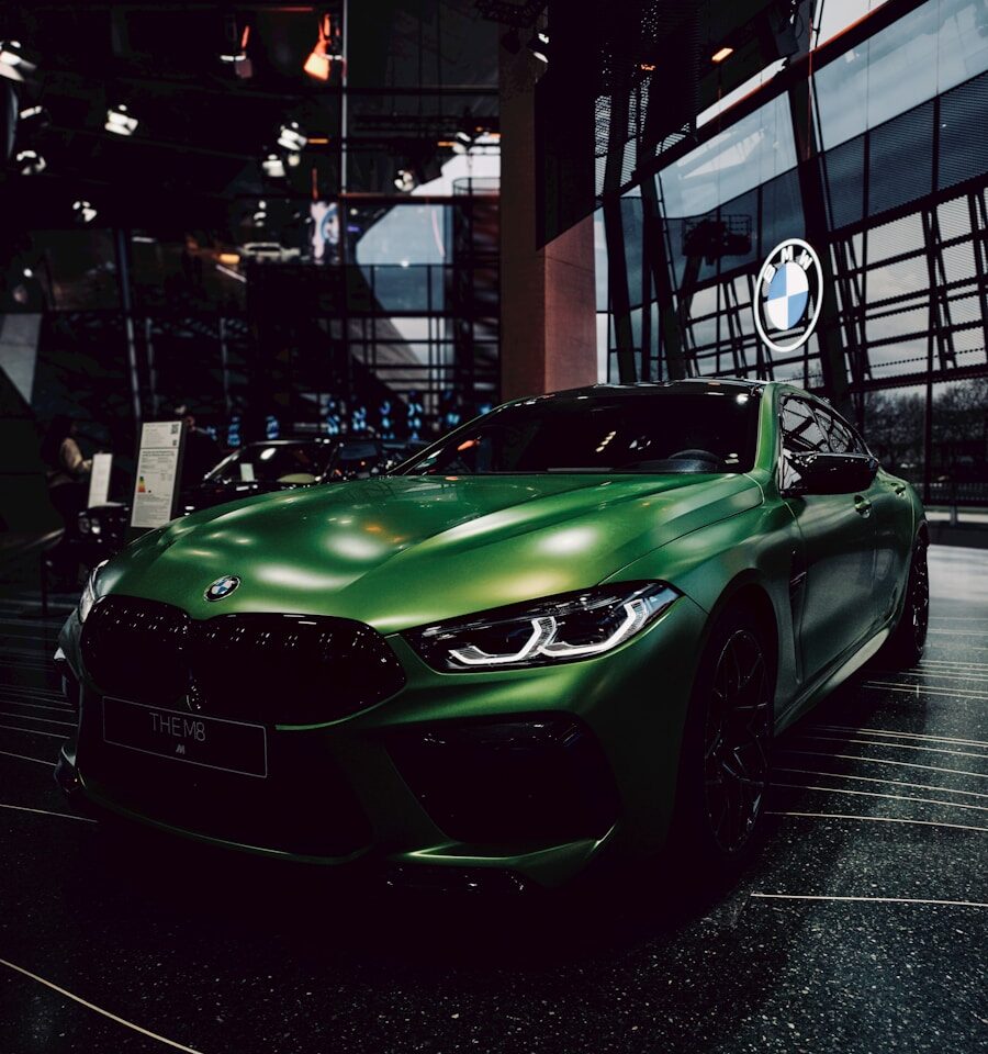 a green sports car parked in a garage